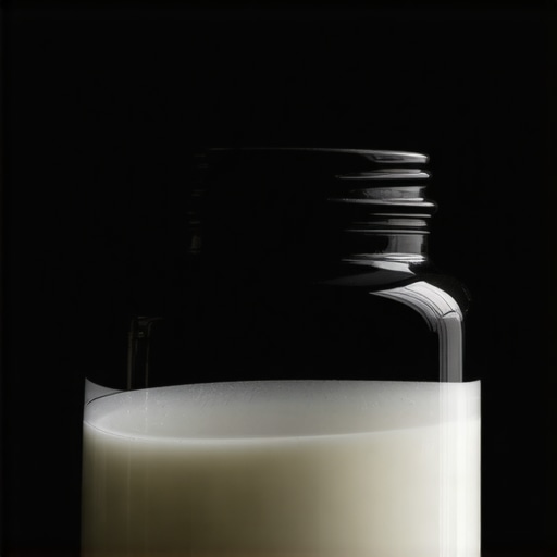 A dark glass jar containing homemade tallow cream stored in a pantry
